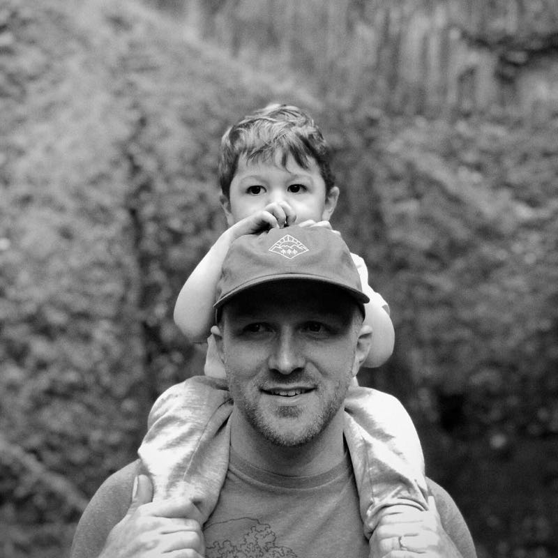 Tyson and his son riding on his shoulders.